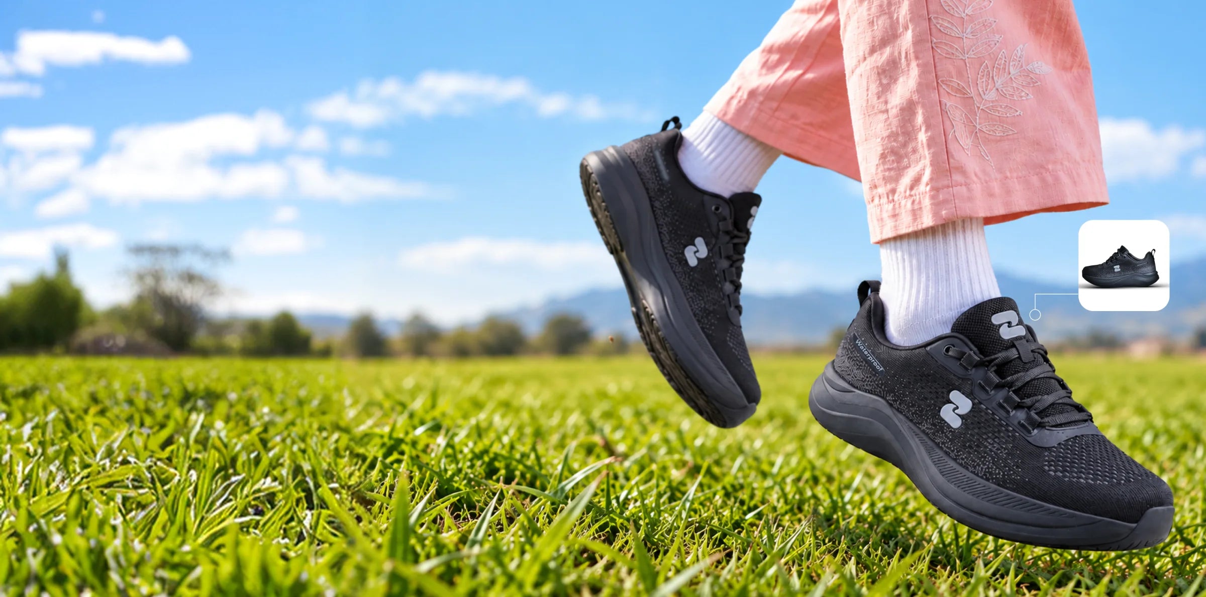 Black OSZEA shoes crossing a grassy field